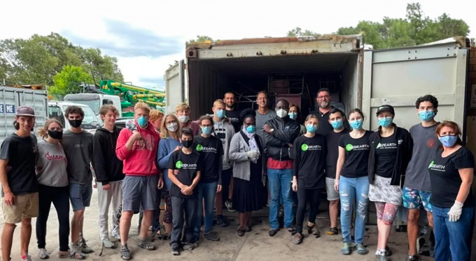 Med Earth - group of volunteers standing in front of a 40 foot container.